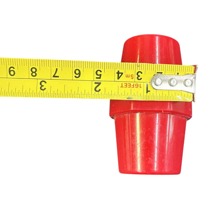 Red plastic pipe fitting with a yellow measuring tape showing its length on a white background