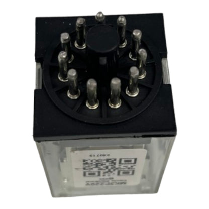 A black and clear electrical relay component with multiple metal pins on top and a white label featuring a QR code on the front, shown against a plain white background.