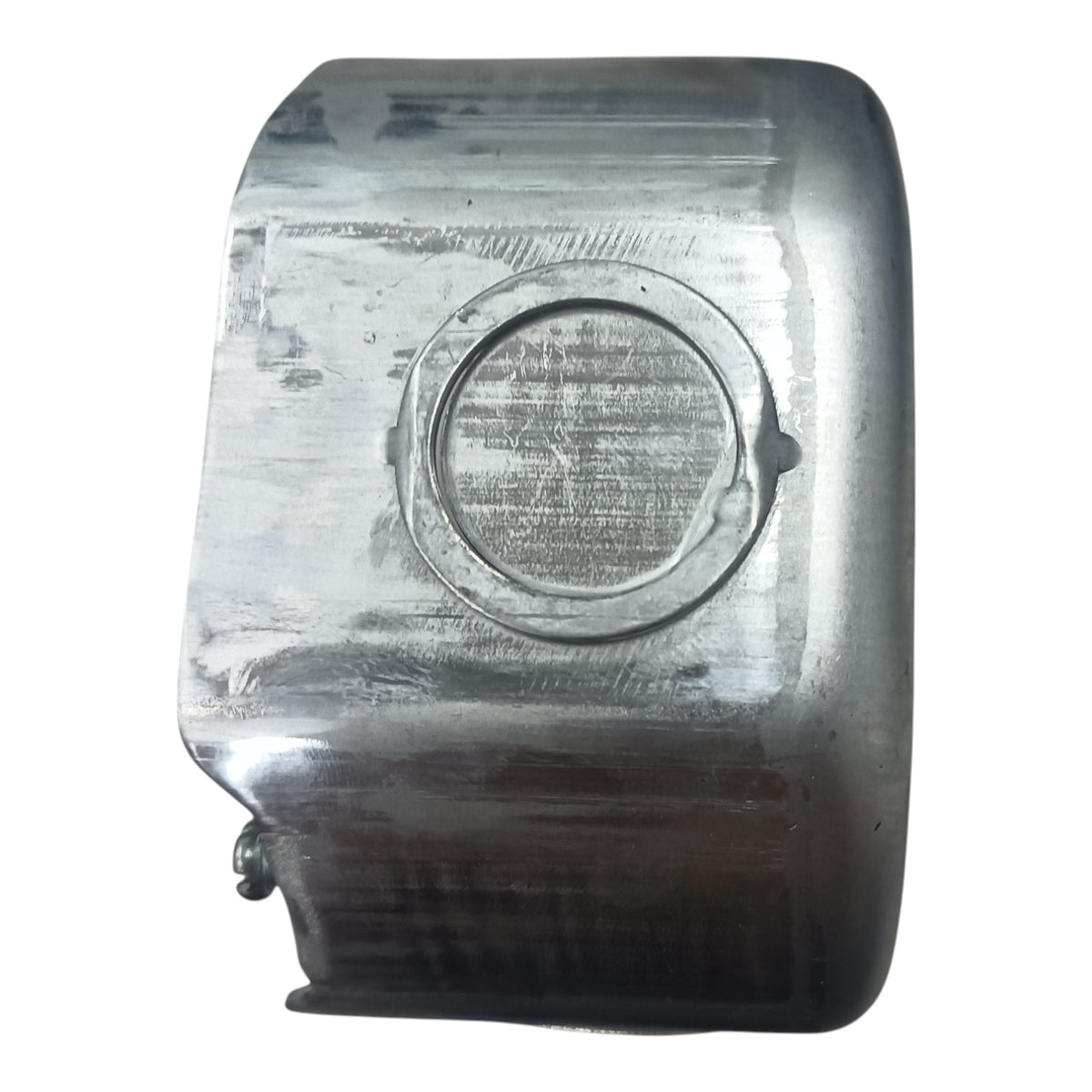 A used metallic silver rectangular component with a circular recessed detail, showing signs of wear, scratches, and heat discoloration, isolated on a white background.