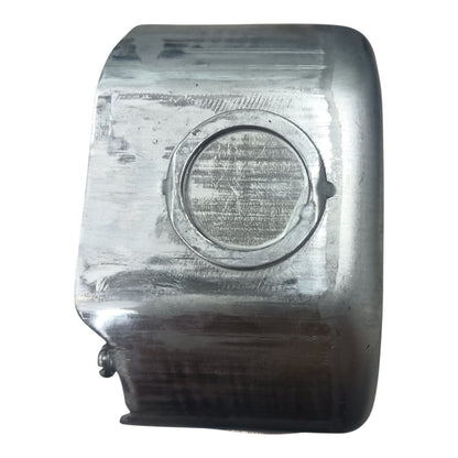 A used metallic silver rectangular component with a circular recessed detail, showing signs of wear, scratches, and heat discoloration, isolated on a white background.