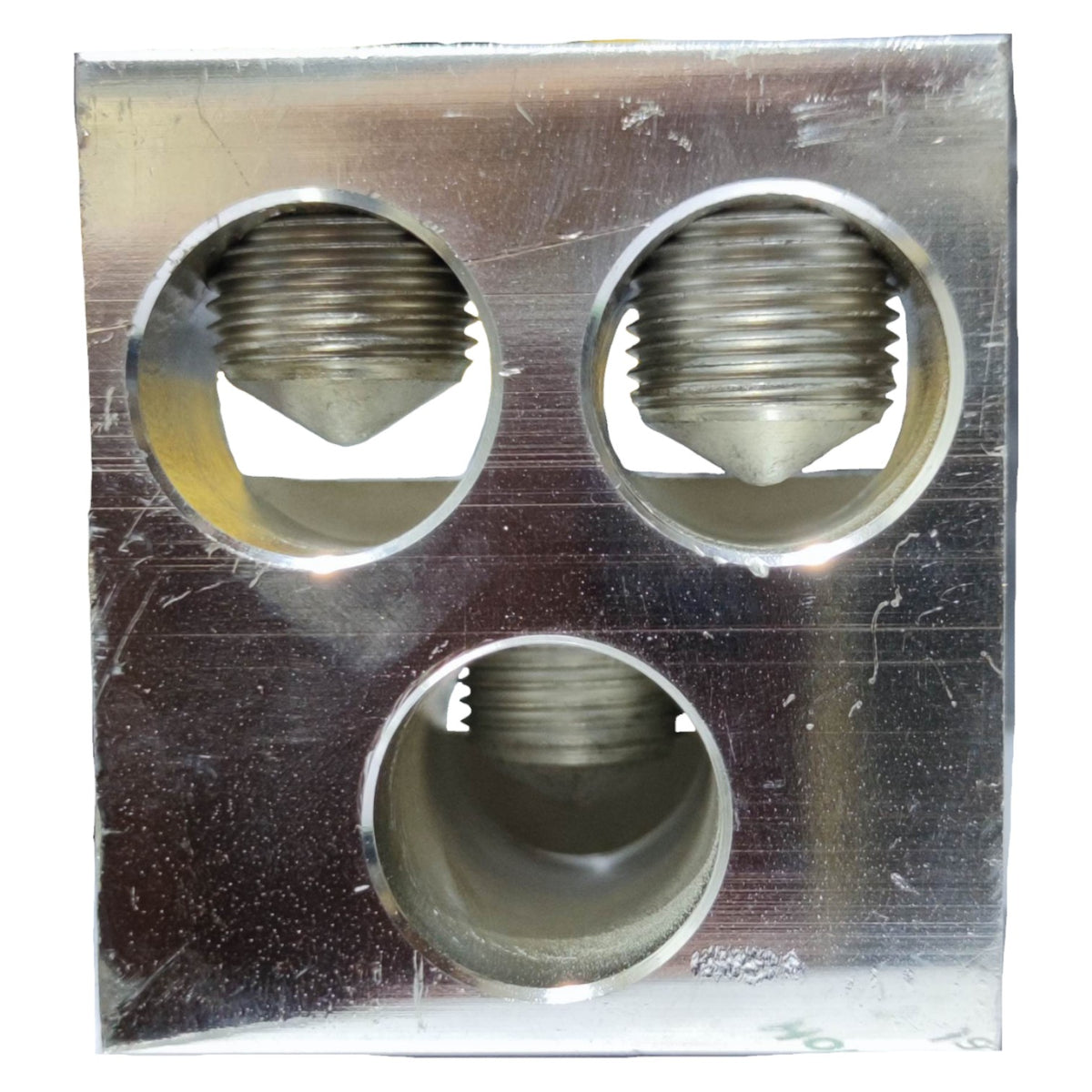Metallic three-hole component on a textured surface
