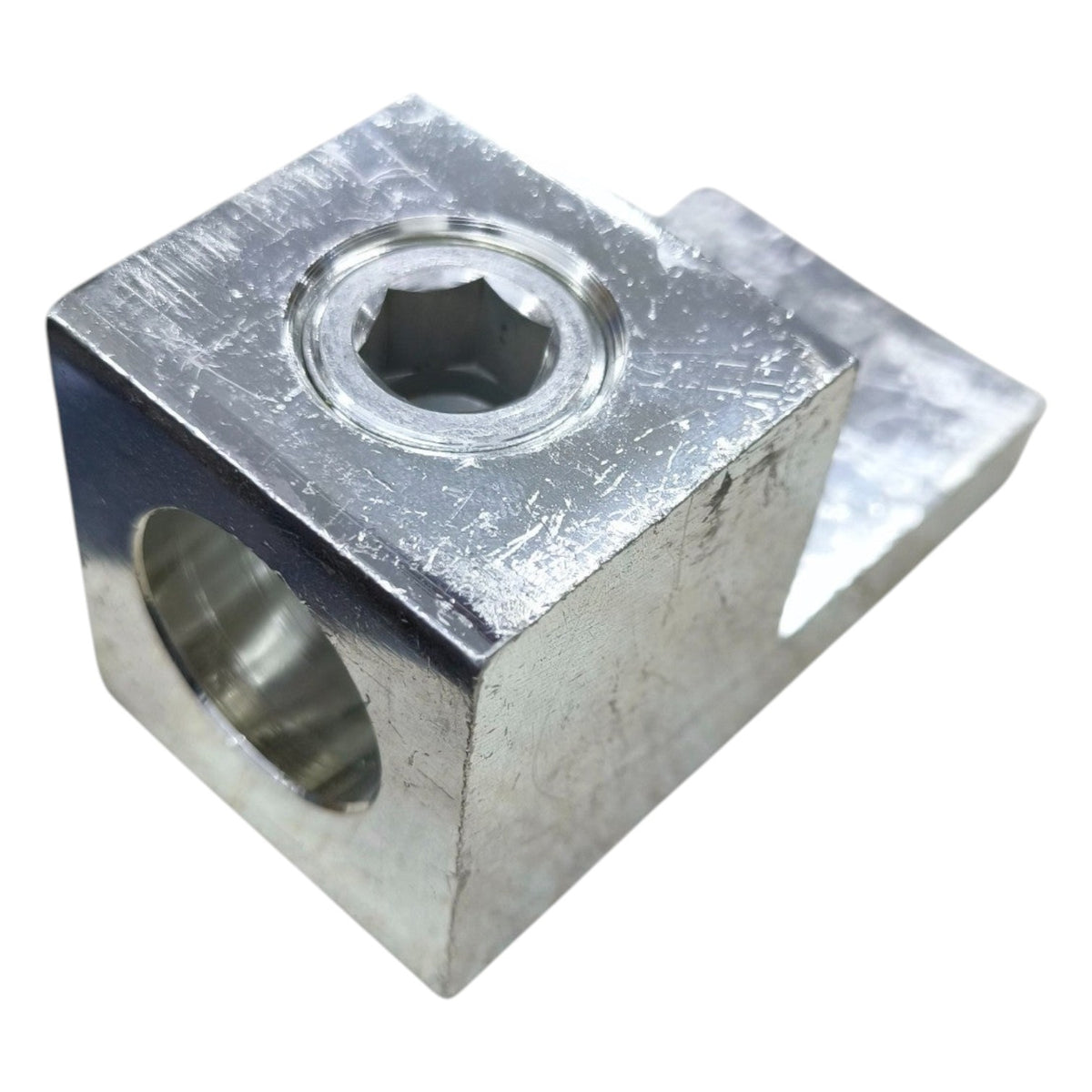Metal block with hexagonal hole on a white background