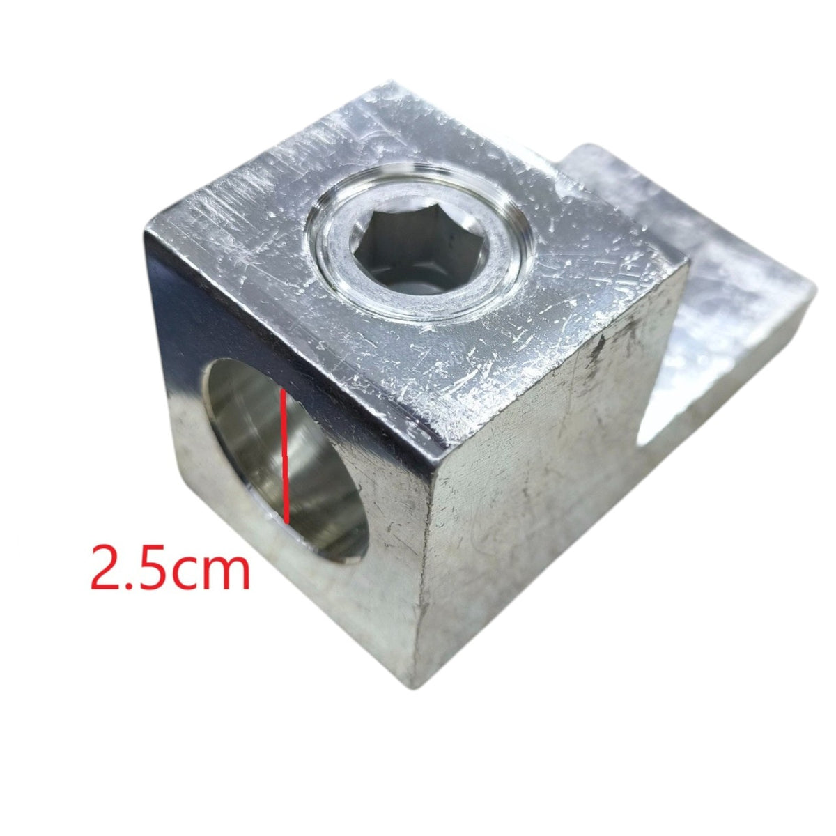 Metal block with two circular holes and a measurement label on a white background