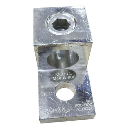 Metal block with multiple holes and 'McGill' branding on a white background