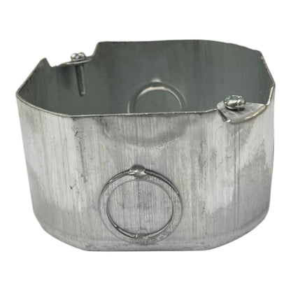 Galvanized steel electrical junction box with a front wire ring and mounting screws, isolated on a white background.