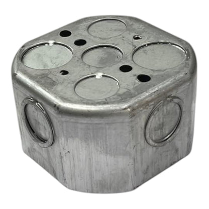 A hexagonal metal electrical junction box with circular mounting holes and ventilation slots, shown on a plain white background.