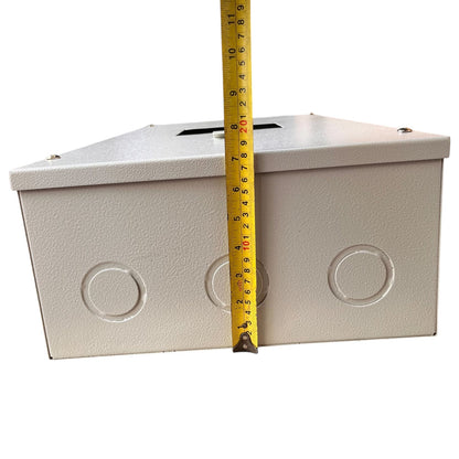 A light gray metal junction box with circular terminal holes on the front, shown with a yellow tape measure standing vertically to indicate its height against a plain white background.