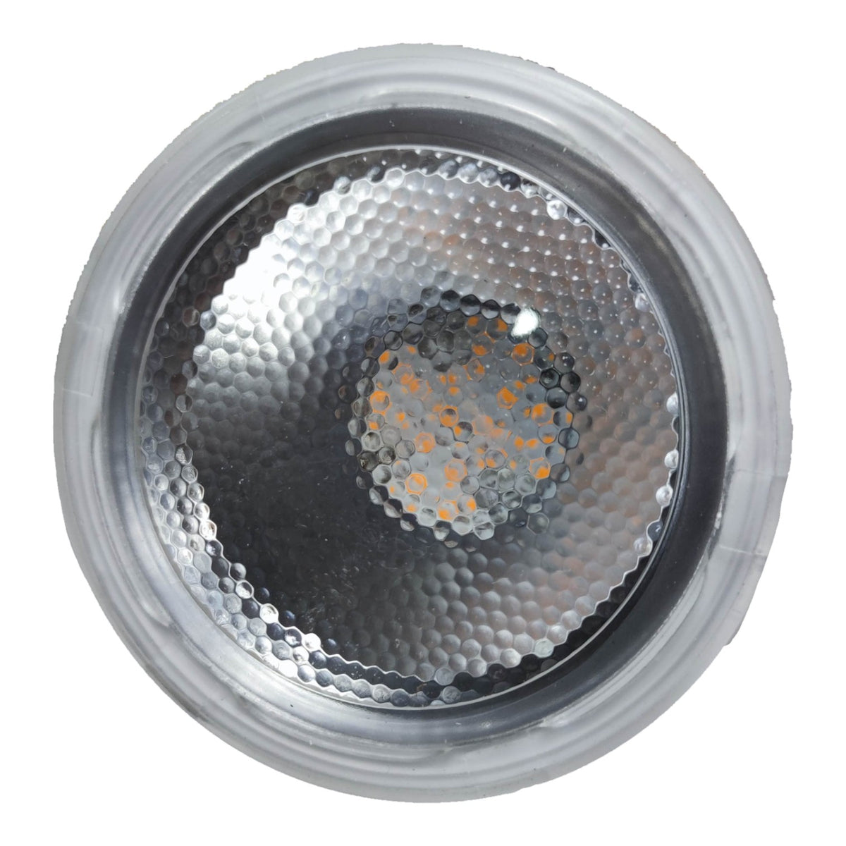 Close-up of a metallic light bulb with a textured surface on a white background