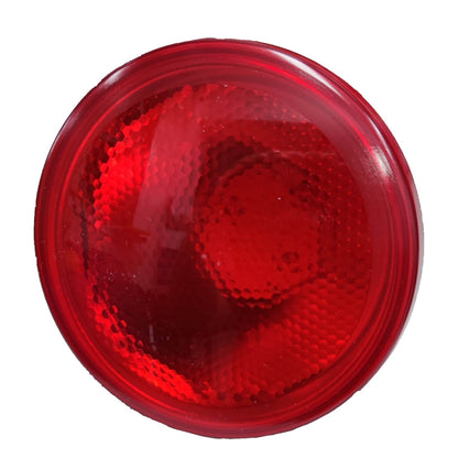 Red round reflective safety light on a white background
