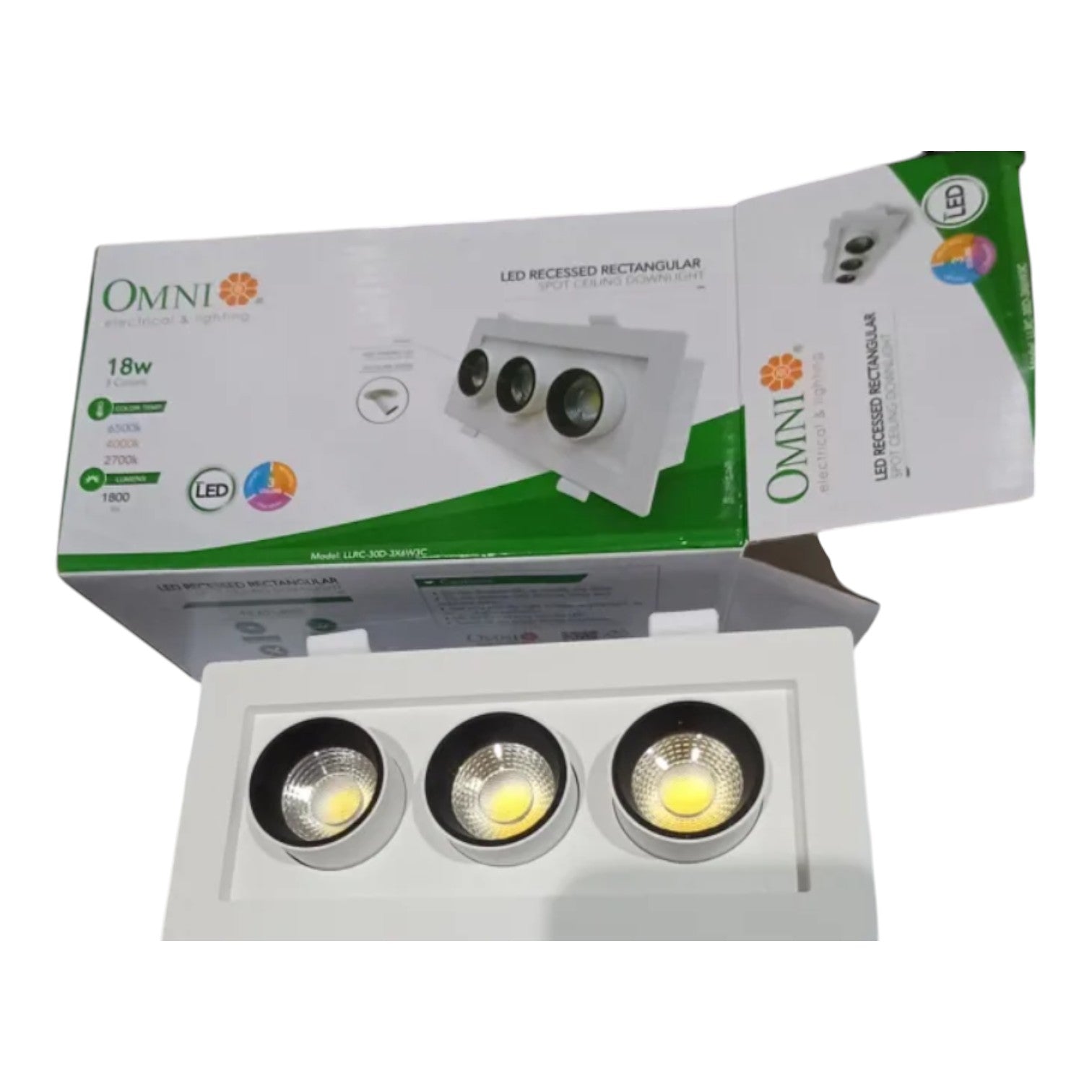 A 3-light recessed LED track spotlight shown with its retail packaging box. The white rectangular spotlight has three circular COB LED lenses, and the box features green and white branding for 'OMNI'.