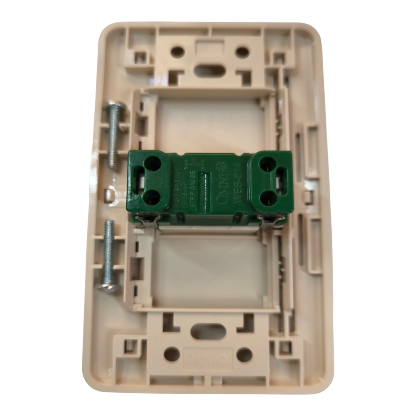 A beige plastic electrical switch socket backplate with a green terminal block and mounting screws, shown on a white background.