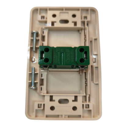 A beige plastic electrical switch socket backplate with a green terminal block and mounting screws, shown on a white background.