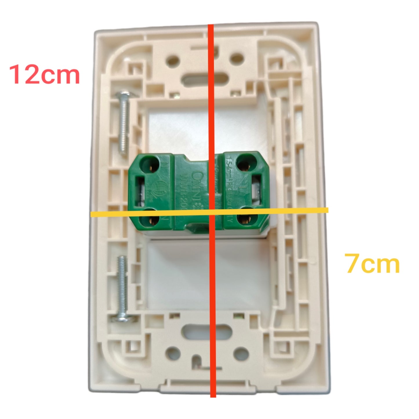 A top-down view of a beige plastic light switch backplate with a green terminal block in the center, overlaid with red and yellow measurement lines and text indicating 12cm and 7cm dimensions.