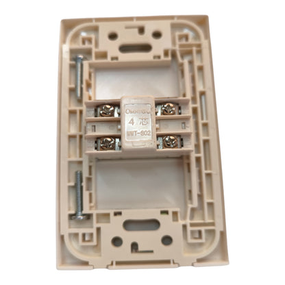 An electrical switch socket backplate with a beige plastic housing, featuring a central terminal block with screws and a central white component labeled 'OMNIGU 4 GWT-8C2'.