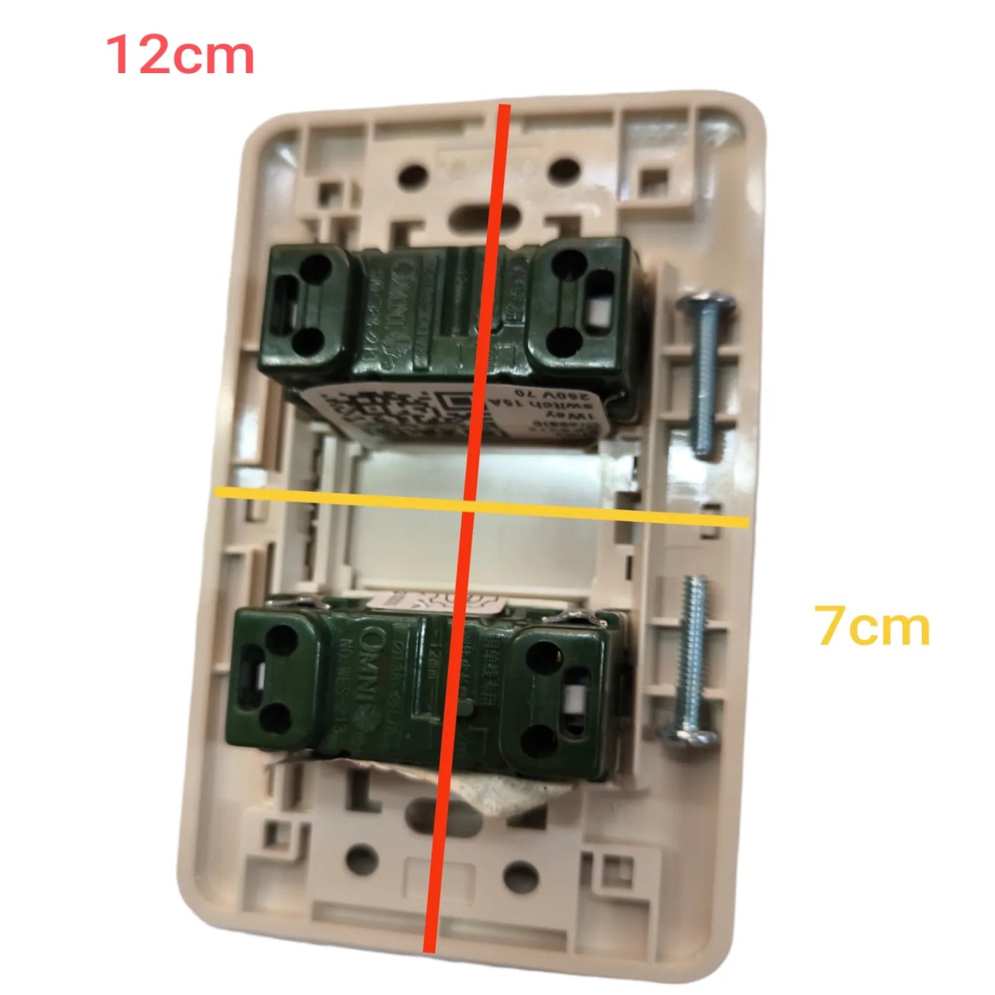 A beige light switch backplate with two dark green terminal blocks and mounting screws, overlaid with red and yellow measurement lines and text reading 12cm and 7cm on a white background.