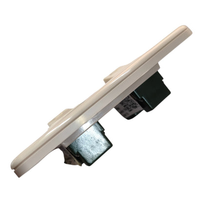 A replacement light switch module with a beige plastic faceplate and dark metal and green internal components, shown on a plain white background.
