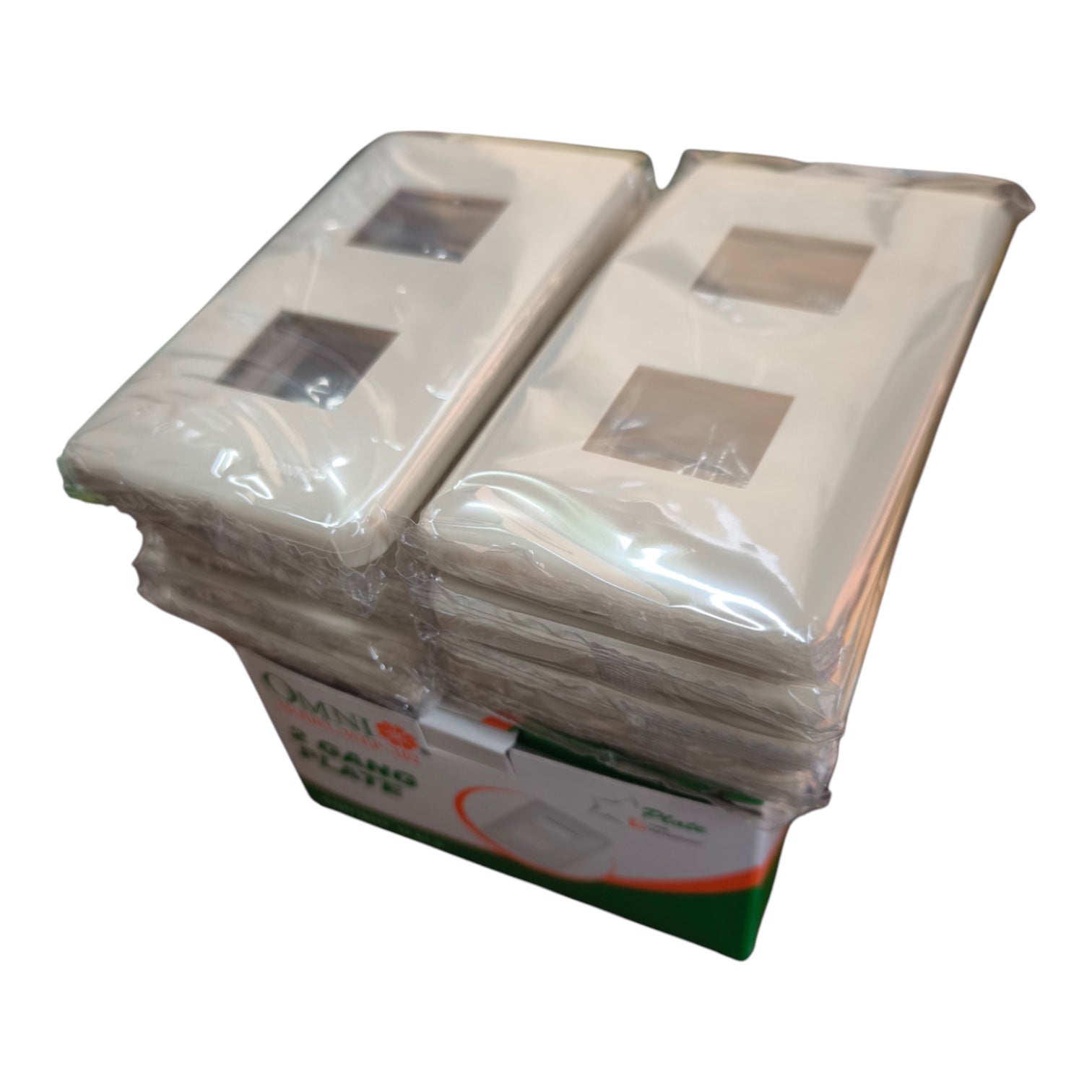 A stack of white mini double-gang wall switch plates wrapped in clear plastic, with a green and white cardboard box visible at the bottom. The brand name 'EMINI' is partially visible on the box.