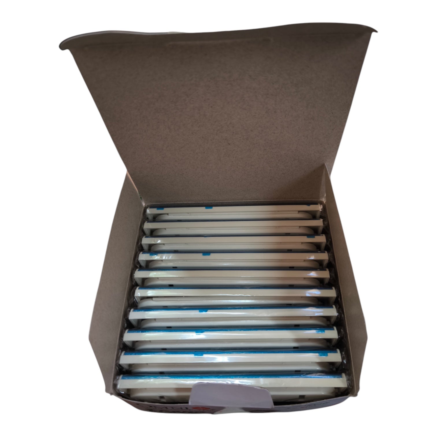 An open brown cardboard box containing multiple long, narrow white items wrapped in clear plastic with blue tape accents, photographed on a plain white background.