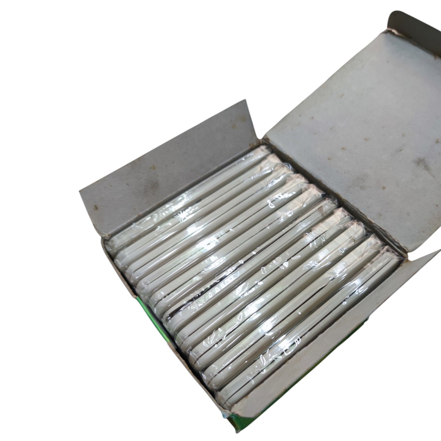 An open cardboard box containing multiple white cylindrical items wrapped in clear plastic, photographed on a plain white background.