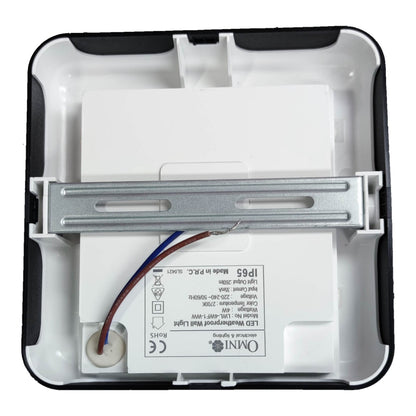 The back side of a square white and black outdoor LED wall light housing, showing the internal metal mounting bracket, wiring, and printed specifications including the Omini brand logo.