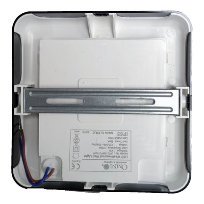 The back side of a white Omni IP68 smart wall light, showing the mounting bracket, internal plastic structure, and wiring.