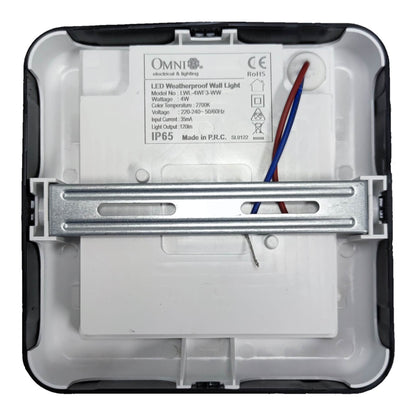 The back of an Omni LED weatherproof wall light, showing the white plastic backplate, metal mounting bracket, and wiring with red and blue wires.