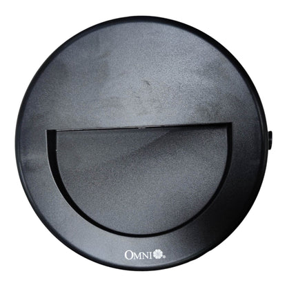 A top-down view of a black circular robotic vacuum cleaner lid, featuring a central semi-circular cutout and the 'OMNI+' brand logo printed in white at the bottom.