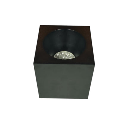 A modern square black LED light fixture with a recessed circular cup and a clear faceted crystal diffuser, shown on a plain white background.