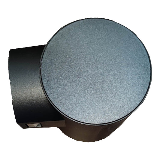 A black cylindrical wall light fixture with a round, textured gray faceplate, shown against a plain white background.