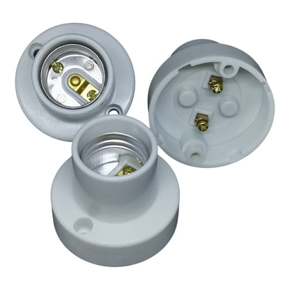 Three white light socket components on a white background