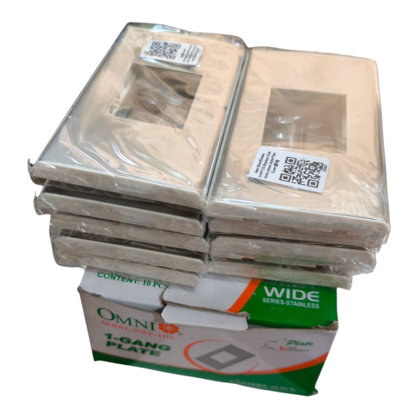 A stack of packaged Omni 1 Gang Plate wide stainless steel light switch plate covers, with the green and white retail box visible at the bottom on a plain white background.