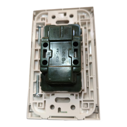 An electrical switch plate backplate with a dark green terminal block connector mounted in the center, photographed on a solid white background.