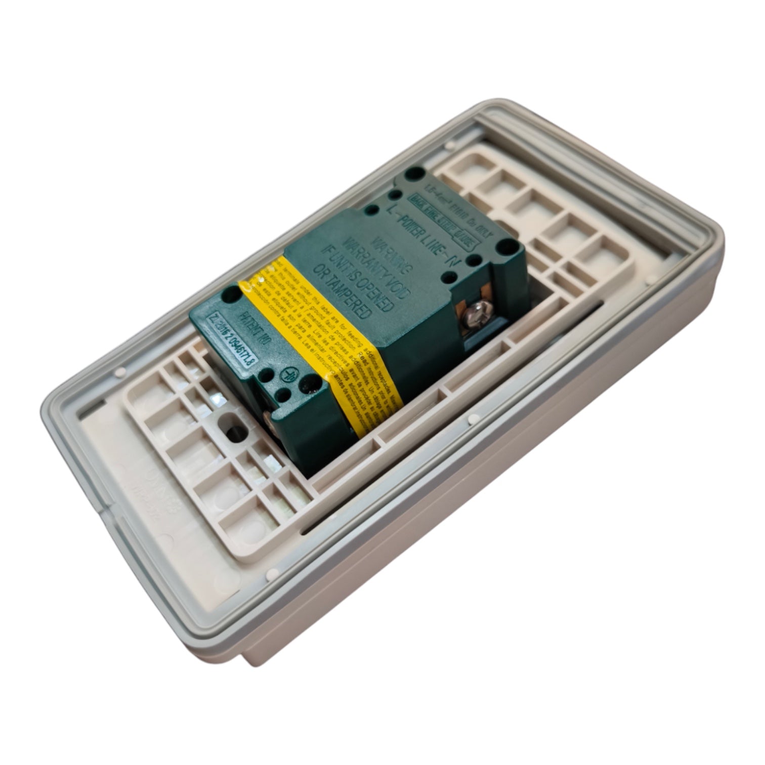 A miniature electrical contact relay inside a beige plastic modular housing, featuring a dark green body with a yellow warning label.