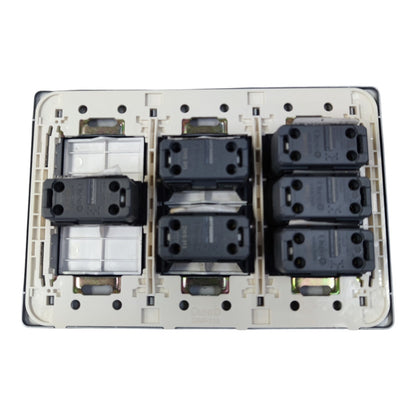 A 6-way dual switch module with black contact elements and a white plastic backplate, photographed from directly above on a white background.