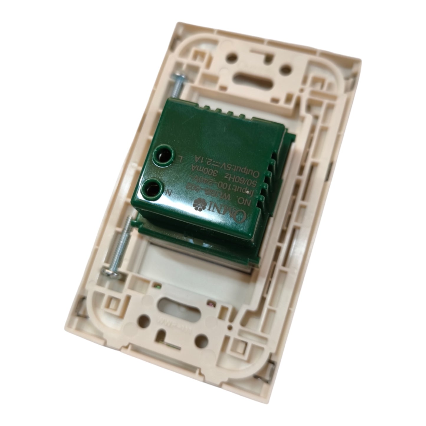 A green electrical relay component mounted on a beige plastic modular circuit board, photographed on a clean white background.