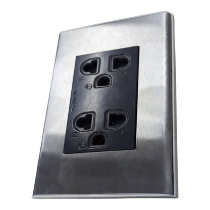 A brushed stainless steel outdoor duplex outlet cover plate with a black plastic insert, shown at an angle on a white background.