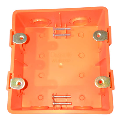 An orange plastic electrical junction box cover with pre-installed brass screw terminals and mounting washers, shown from a top-down view on a white background.