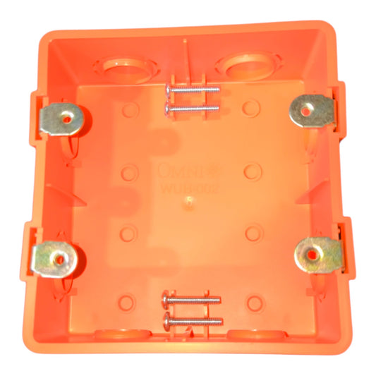 An orange plastic electrical junction box cover with pre-installed brass screw terminals and mounting washers, shown from a top-down view on a white background.