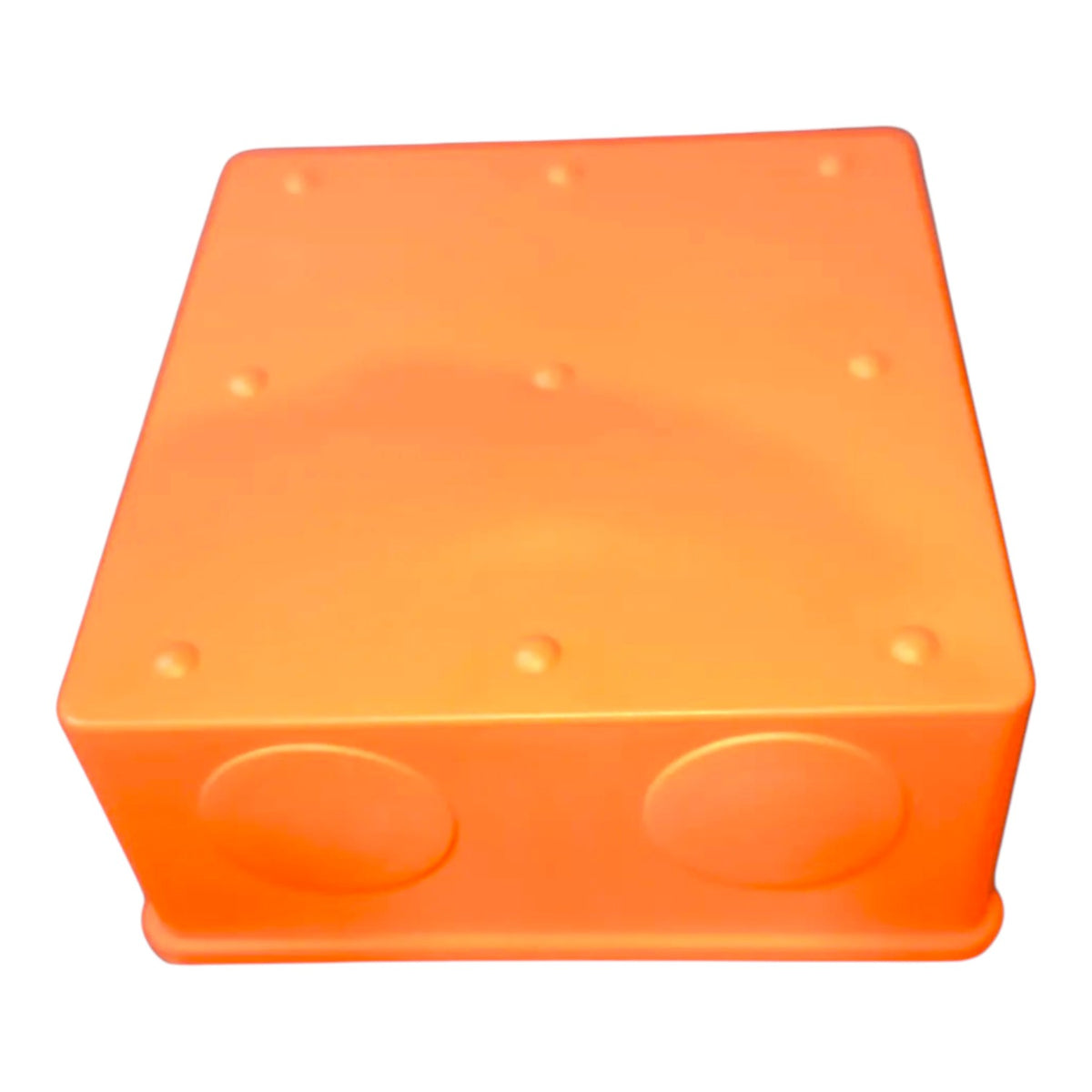 An orange plastic junction box with two circular entry ports on the front face and small raised dots on the top surface, shown against a plain white background.