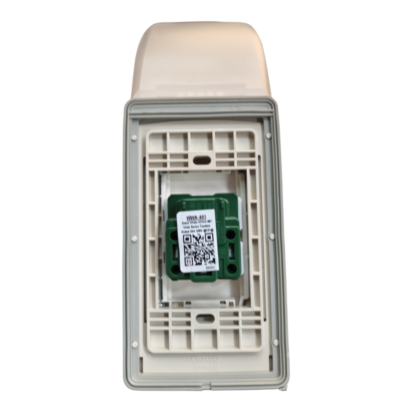 An outdoor electrical outlet cover with a beige plastic top and a gray plastic frame, showing the interior mounting plate and a green electronic component with a QR code label.