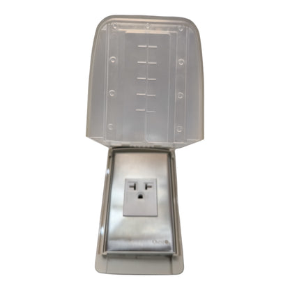 A stainless steel outdoor electrical outlet covered by a clear, molded plastic rain guard and weatherproof cap, shown against a plain white background.