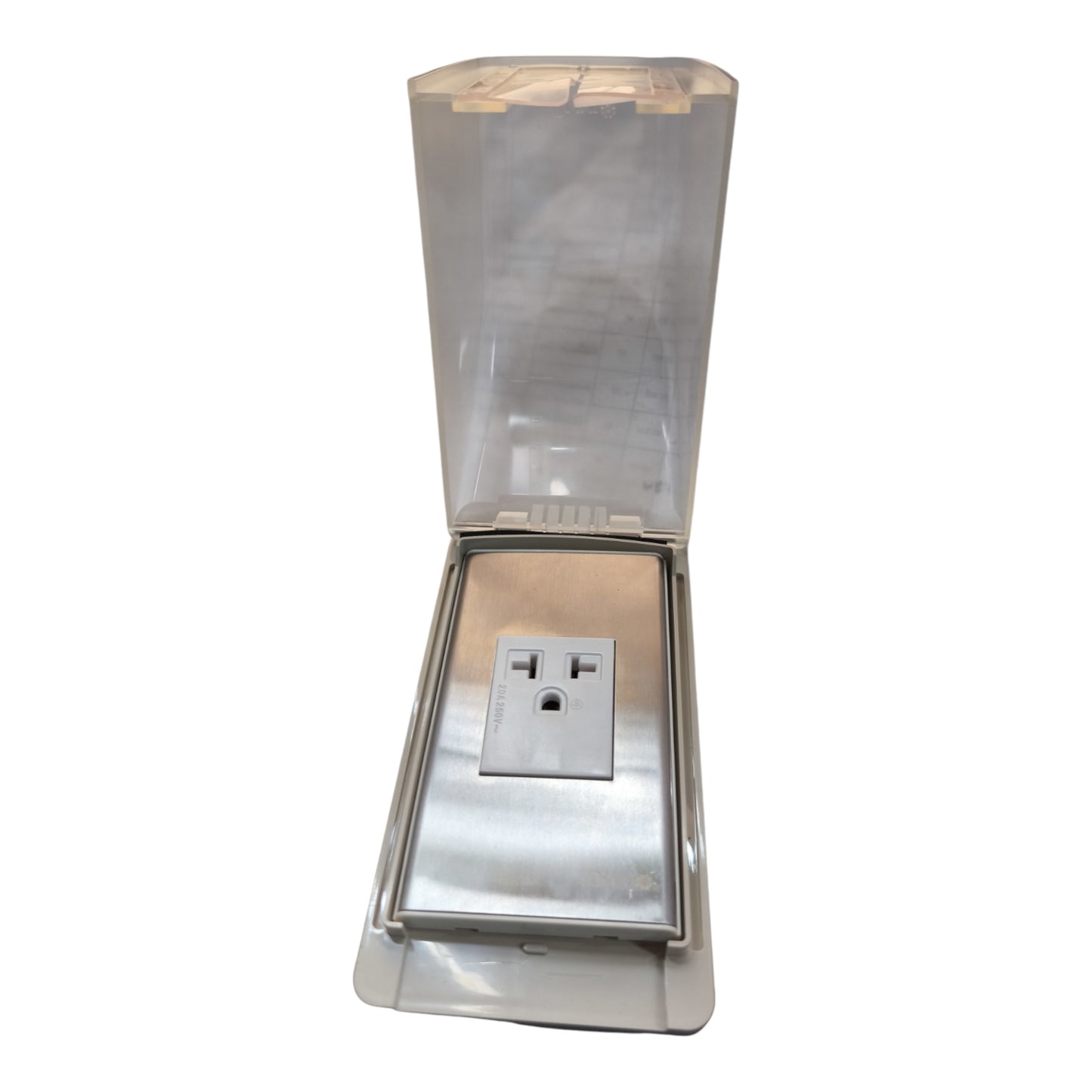 A stainless steel outdoor electrical outlet covered by a clear, weather-resistant protective hood with a hinged translucent lid, shown against a plain white background.