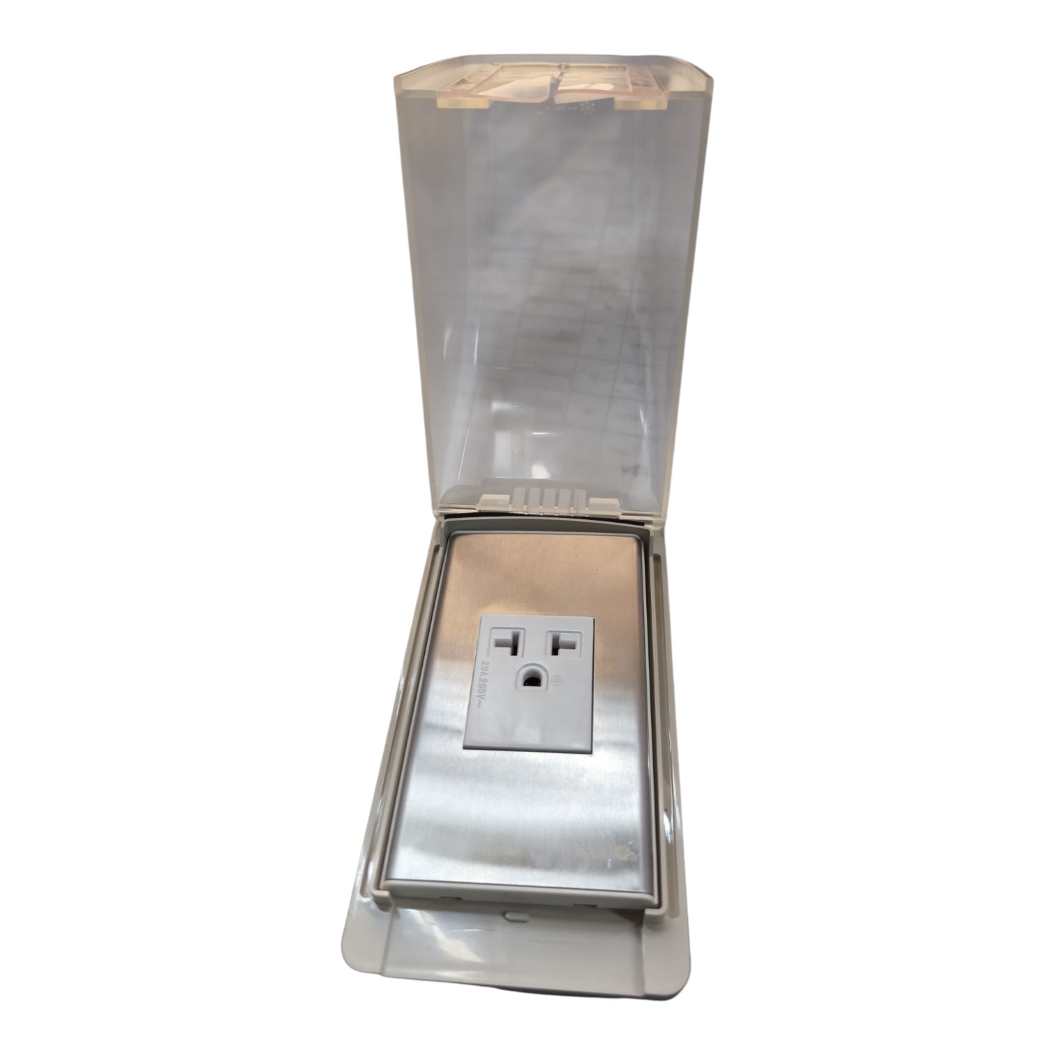 A stainless steel outdoor electrical outlet covered by a clear, weather-resistant protective hood with a hinged translucent lid, shown against a plain white background.