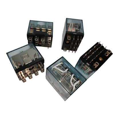 Four industrial electrical relays with transparent housings, showing internal wiring and metal terminals, arranged on a plain white background.
