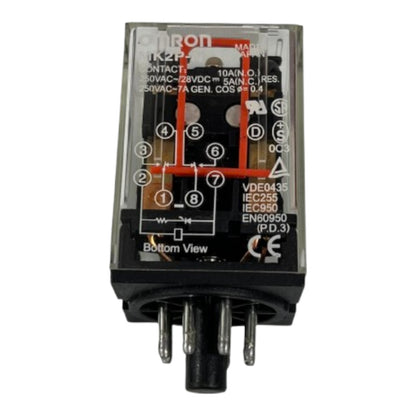 An Omron TK2P relay component with a clear plastic casing, black internal structure, printed red and white schematic diagrams, and multiple metal terminal pins at the bottom, shown on a plain white background.