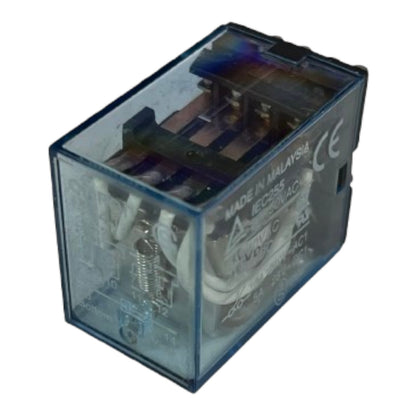 A small transparent blue electrical relay with internal metal contacts and wiring, photographed on a plain white background. Visible text includes 'MADE IN MALAYSIA', 'CE', and '100VAC'.