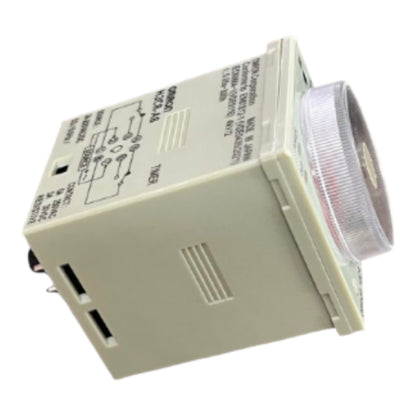 An industrial electrical timer relay unit with a beige plastic housing, printed circuit diagrams on the side, and a clear ribbed lens covering the front timer coil.