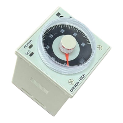 An Omron HSCR 24V DC timer relay with a square beige plastic housing, featuring a clear protective cover over a black dial with a red pointer, and power/OUT terminal labels on the side.