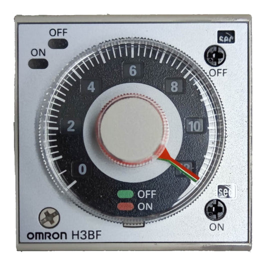 An Omron H3BF analog timer module with a silver metal faceplate, a large black dial with white markings, and red and green ON/OFF indicator lights.