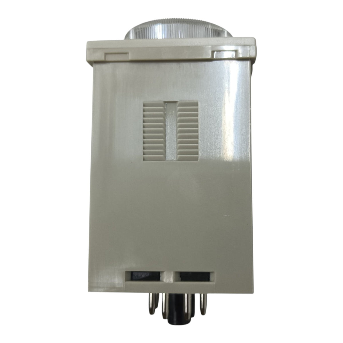 A rectangular metal light fixture or lamp housing with a silver-gray body, a ribbed circular top, vented slits on the front, and metal pins at the bottom, isolated on a white background.